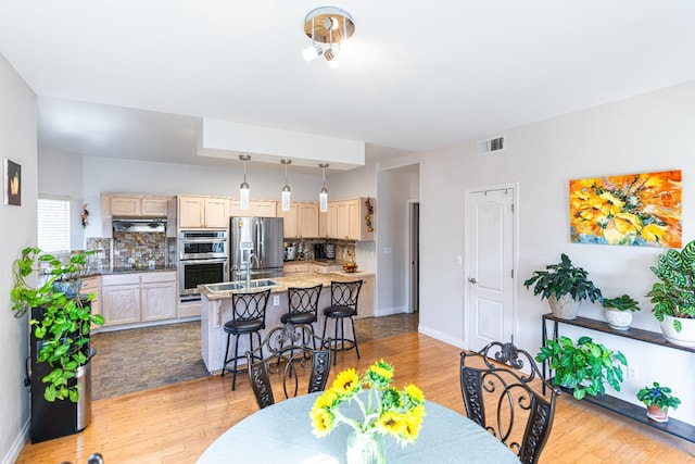 2322 E Revere Rd, Fresno, CA 93720 - dining space featuring light wood-type flooring and baseboards