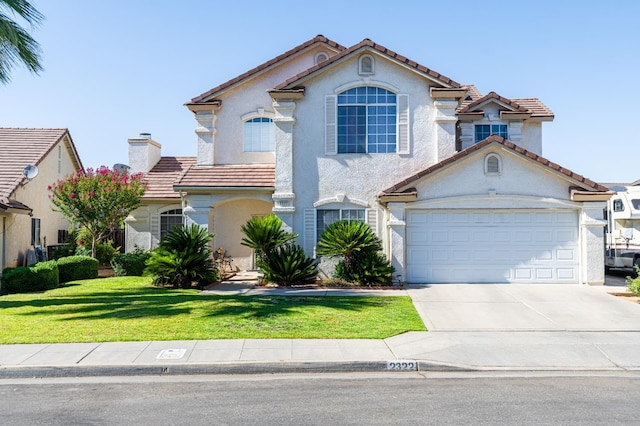 2322 E Revere Rd, Fresno, CA 93720 - view of front of property with stucco siding, concrete driveway, a tiled roof, and a front yard
