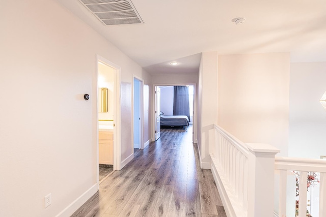 2322 E Revere Rd, Fresno, CA 93720 - corridor with light wood finished floors and an upstairs landing