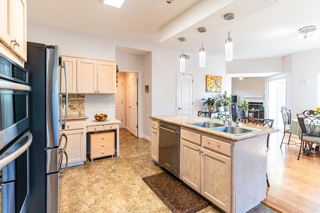 2322 E Revere Rd, Fresno, CA 93720 - kitchen with light brown cabinetry, stainless steel appliances, a center island with sink, light countertops, and decorative light fixtures