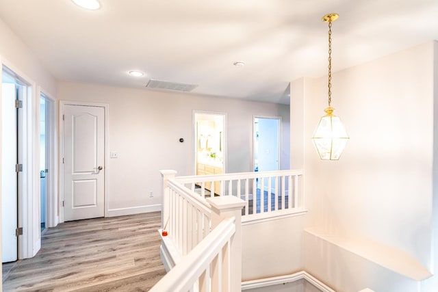 2322 E Revere Rd, Fresno, CA 93720 - hallway with an upstairs landing, light wood-type flooring, and recessed lighting