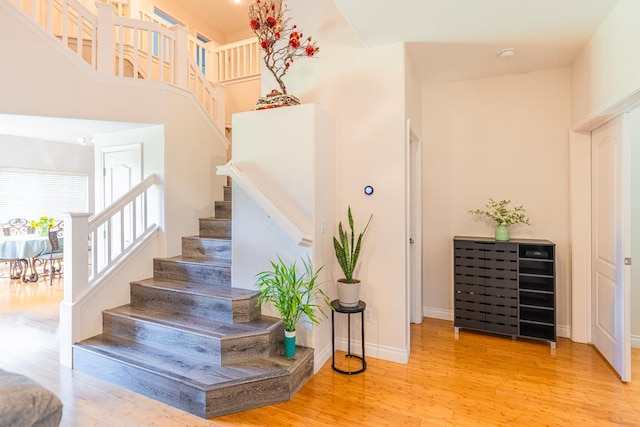 2322 E Revere Rd, Fresno, CA 93720 - staircase featuring wood finished floors and a high ceiling