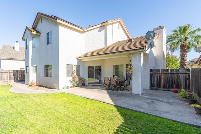 2322 E Revere Rd, Fresno, CA 93720 - rear view of house featuring a fenced backyard, stucco siding, a patio, and a tile roof