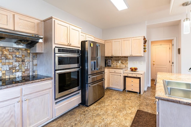 2322 E Revere Rd, Fresno, CA 93720 - kitchen with appliances with stainless steel finishes, light brown cabinets, backsplash, under cabinet range hood, and pendant lighting