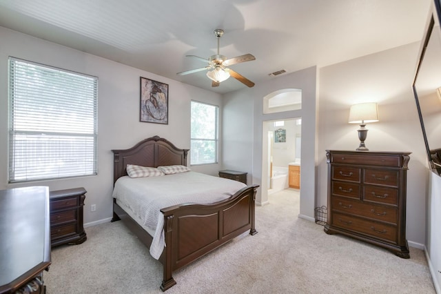 7515 N Wheeler Ave, Fresno, CA 93722 - bedroom featuring light colored carpet, ensuite bath, and a ceiling fan