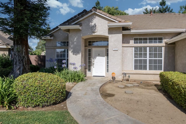 7515 N Wheeler Ave, Fresno, CA 93722 - property entrance featuring stucco siding and a tiled roof