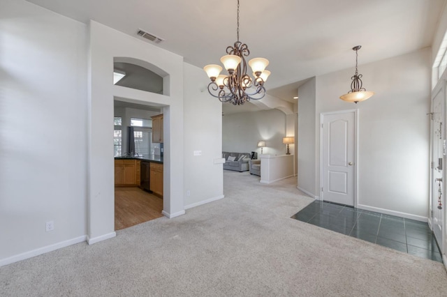 7515 N Wheeler Ave, Fresno, CA 93722 - carpeted entryway featuring baseboards and a chandelier