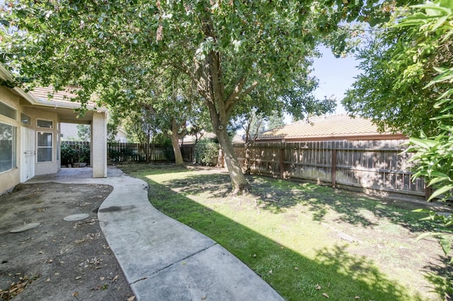7515 N Wheeler Ave, Fresno, CA 93722 - fenced backyard featuring a patio