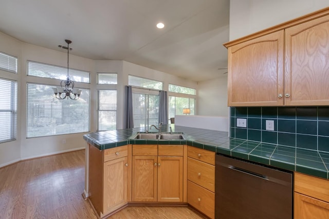 7515 N Wheeler Ave, Fresno, CA 93722 - kitchen featuring stainless steel dishwasher, light wood-style flooring, a chandelier, a peninsula, and tile counters