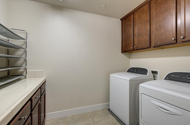 3669 N Clover Ave, Fresno, CA 93727 - washroom with washing machine and dryer, cabinet space, and light tile patterned flooring