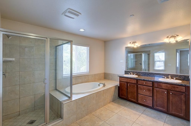 3669 N Clover Ave, Fresno, CA 93727 - bathroom with double vanity, tile patterned floors, a bath, and a stall shower
