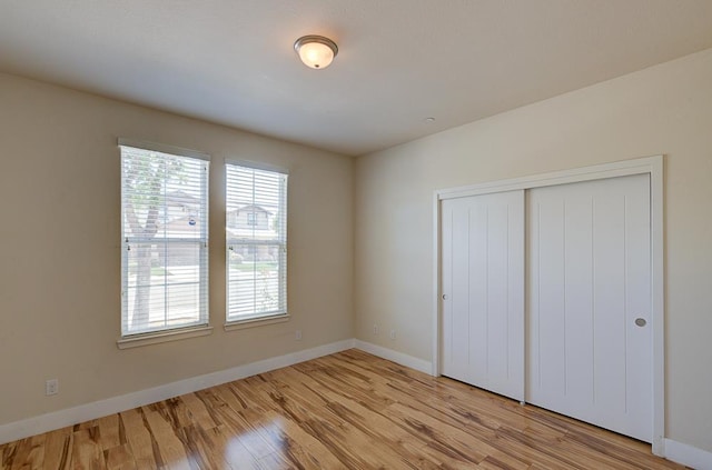 3669 N Clover Ave, Fresno, CA 93727 - unfurnished bedroom featuring light wood finished floors and a closet