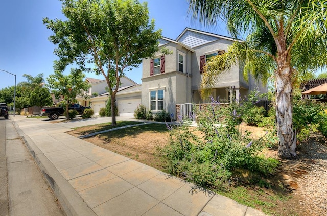 3669 N Clover Ave, Fresno, CA 93727 - view of front of house with driveway, stucco siding, and a garage