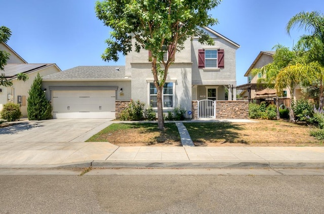 3669 N Clover Ave, Fresno, CA 93727 - view of front facade with stucco siding, an attached garage, driveway, and a gate