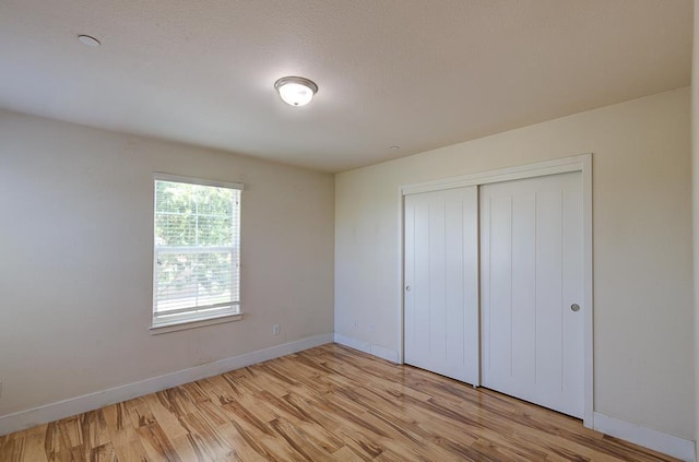 3669 N Clover Ave, Fresno, CA 93727 - unfurnished bedroom with light wood-type flooring and a closet