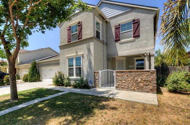 3669 N Clover Ave, Fresno, CA 93727 - view of front facade with a garage, stucco siding, stone siding, concrete driveway, and a gate
