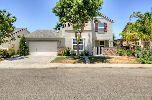 3669 N Clover Ave, Fresno, CA 93727 - view of front of house featuring a garage, concrete driveway, and stucco siding