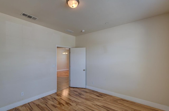 3669 N Clover Ave, Fresno, CA 93727 - empty room with wood finished floors and a smoke detector