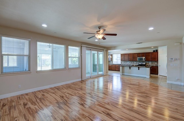 3669 N Clover Ave, Fresno, CA 93727 - unfurnished living room with light wood-type flooring, ceiling fan, and recessed lighting