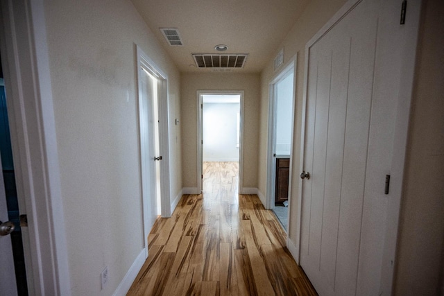 3669 N Clover Ave, Fresno, CA 93727 - corridor with light wood-style flooring and baseboards