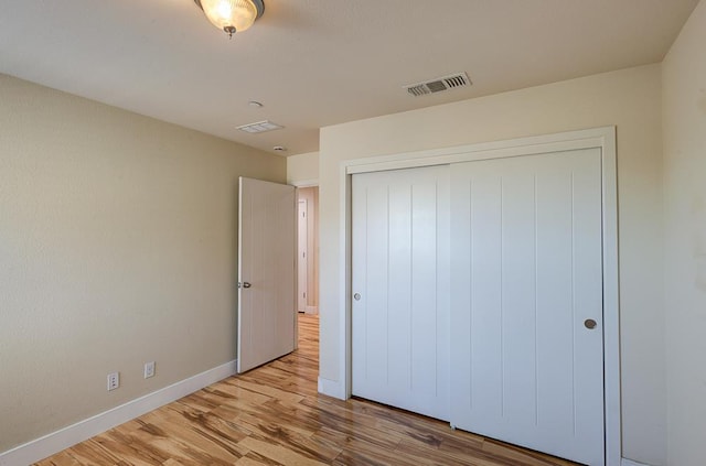 3669 N Clover Ave, Fresno, CA 93727 - unfurnished bedroom featuring wood finished floors and a closet