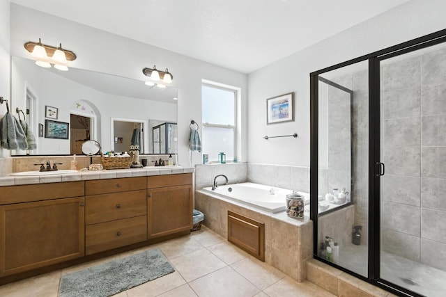 5822 E Booker Ave, Fresno, CA 93727 - full bathroom featuring a shower stall, a garden tub, double vanity, and tile patterned flooring