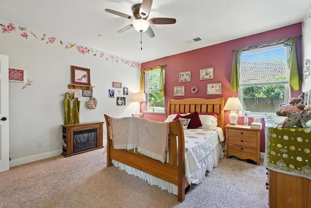 5822 E Booker Ave, Fresno, CA 93727 - bedroom featuring carpet flooring, a ceiling fan, and a glass covered fireplace