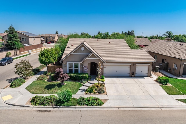 5822 E Booker Ave, Fresno, CA 93727 - view of front of house featuring a garage, stucco siding, driveway, a tile roof, and a residential view