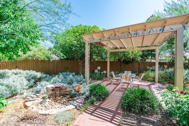 5822 E Booker Ave, Fresno, CA 93727 - fenced backyard featuring a pergola and outdoor dining space