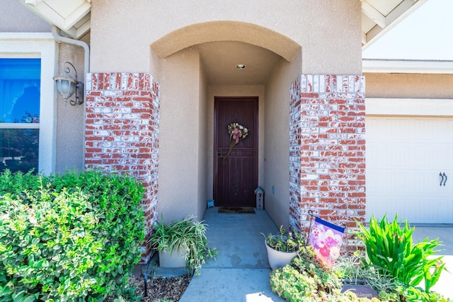 5822 E Booker Ave, Fresno, CA 93727 - property entrance featuring stucco siding, brick siding, and an attached garage
