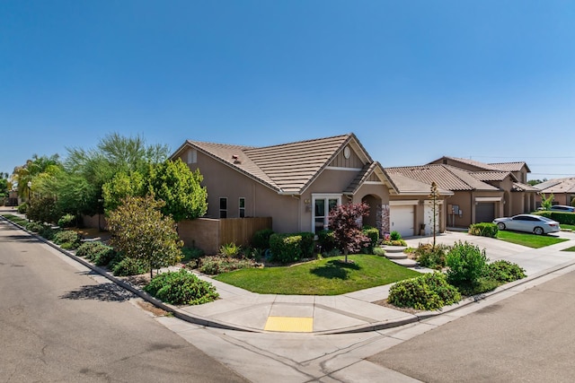 5822 E Booker Ave, Fresno, CA 93727 - view of front of property with a tile roof, a garage, concrete driveway, and stucco siding