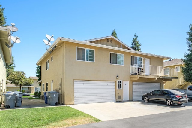 486 W Alamos Ave Unit 3, Clovis, CA 93612 - view of front facade featuring an attached garage, driveway, stucco siding, and stairs