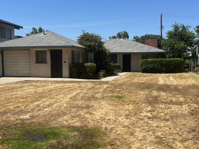 111 E Eden Ave E, Fresno, CA 93706 - single story home featuring a garage, driveway, and a front lawn
