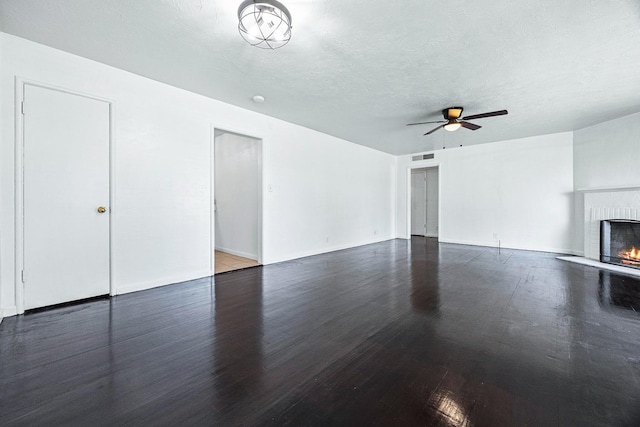 3677 N Thesta St, Fresno, CA 93726 - unfurnished living room with a fireplace, wood finished floors, a ceiling fan, and a textured ceiling