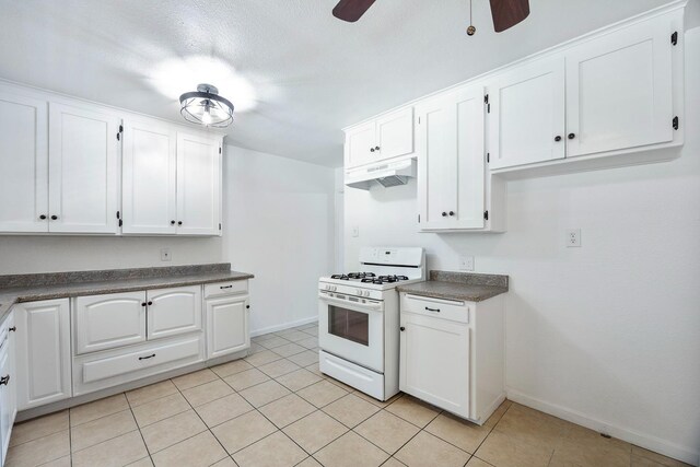 3677 N Thesta St, Fresno, CA 93726 - kitchen with white range with gas stovetop, under cabinet range hood, ceiling fan, and white cabinets