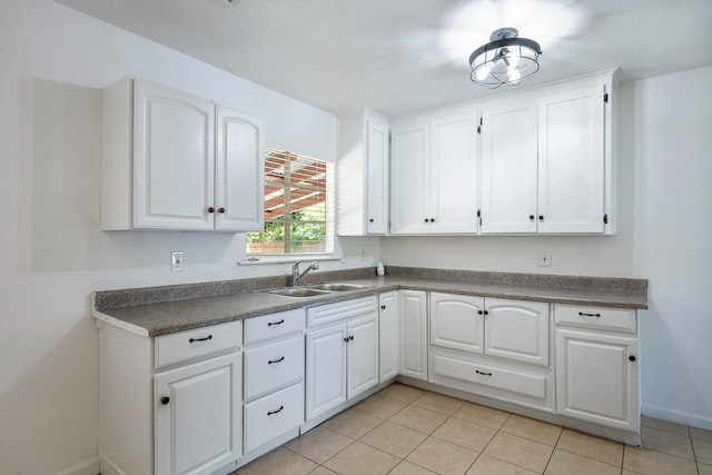 3677 N Thesta St, Fresno, CA 93726 - kitchen with white cabinets, dark countertops, and light tile patterned floors