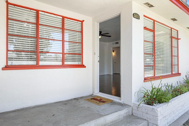 3677 N Thesta St, Fresno, CA 93726 - view of exterior entry featuring stucco siding and a patio area