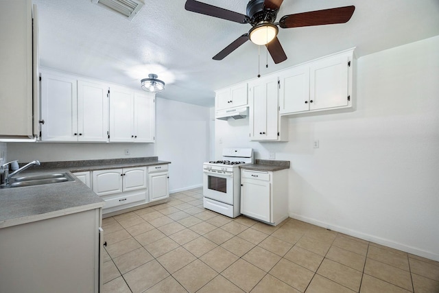 3677 N Thesta St, Fresno, CA 93726 - kitchen featuring white gas range, under cabinet range hood, ceiling fan, and white cabinets