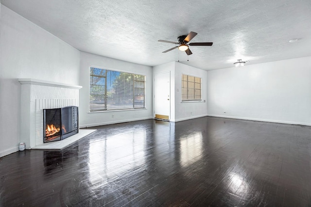 3677 N Thesta St, Fresno, CA 93726 - unfurnished living room featuring a brick fireplace, wood finished floors, a ceiling fan, and a textured ceiling