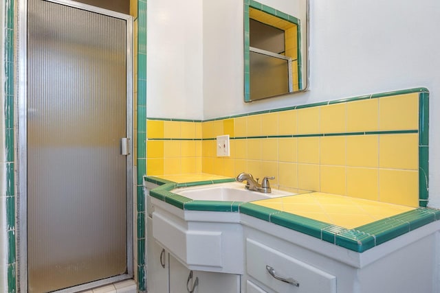 3677 N Thesta St, Fresno, CA 93726 - full bathroom with a stall shower, vanity, tile walls, and wainscoting