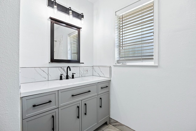3677 N Thesta St, Fresno, CA 93726 - full bath with vanity, marble finish floors, and backsplash