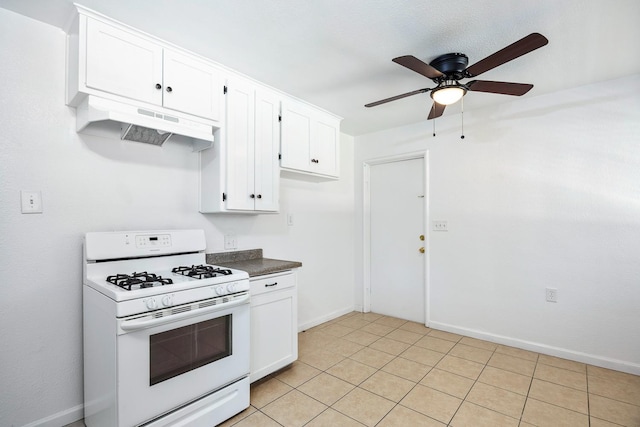3677 N Thesta St, Fresno, CA 93726 - kitchen featuring white range with gas stovetop, under cabinet range hood, white cabinets, a ceiling fan, and dark countertops