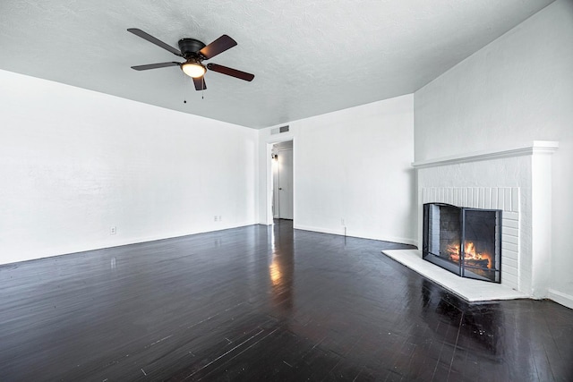 3677 N Thesta St, Fresno, CA 93726 - unfurnished living room with dark wood finished floors, a brick fireplace, a ceiling fan, and a textured ceiling