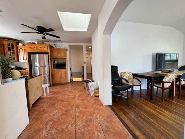 1925 E 15th, Oakland, CA 94606 - kitchen with appliances with stainless steel finishes, brown cabinets, a ceiling fan, and arched walkways