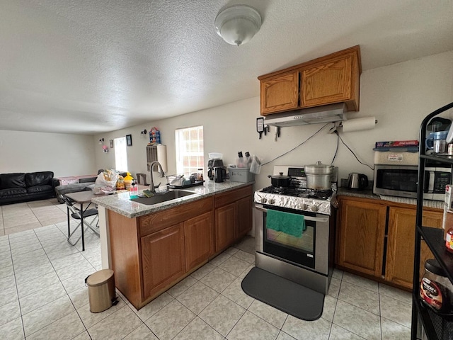 1925 E 15th, Oakland, CA 94606 - kitchen with appliances with stainless steel finishes, under cabinet range hood, brown cabinetry, open floor plan, and light tile patterned flooring