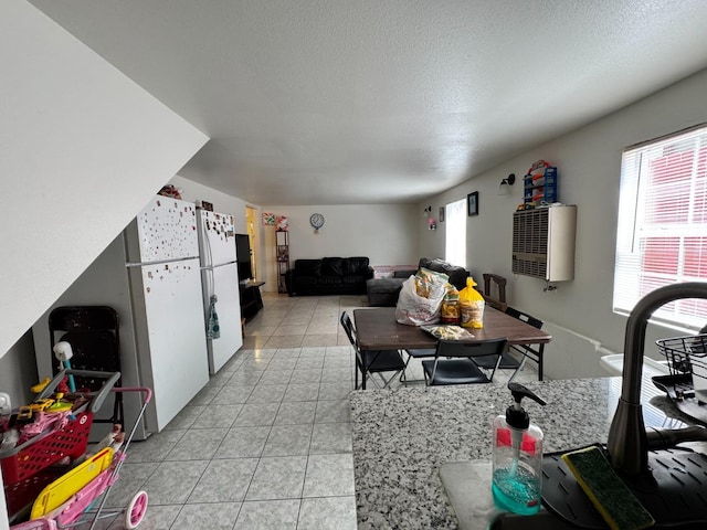 1925 E 15th, Oakland, CA 94606 - kitchen featuring light tile patterned floors, a textured ceiling, and freestanding refrigerator