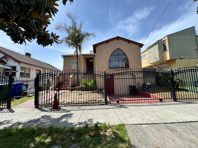 1925 E 15th, Oakland, CA 94606 - mediterranean / spanish house featuring stucco siding, a fenced front yard, and a gate