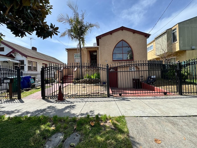 1925 E 15th, Oakland, CA 94606 - view of front of property featuring stucco siding, a fenced front yard, and a gate