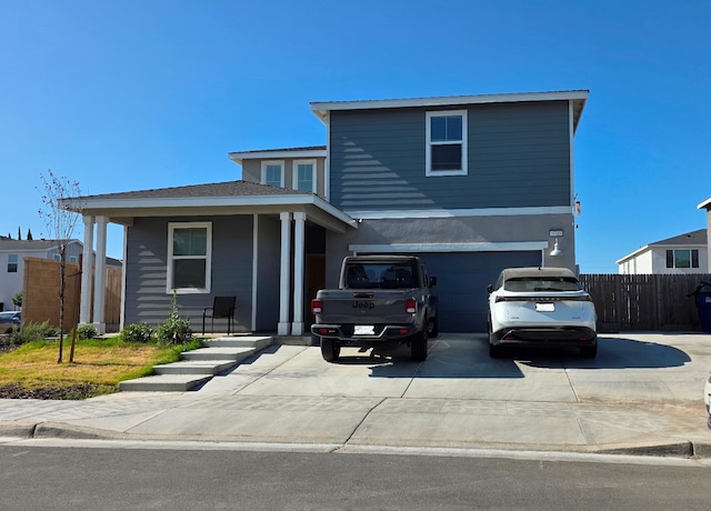 5769 W Austin Way, Fresno, CA 93722 - traditional-style home featuring driveway, an attached garage, covered porch, and stucco siding