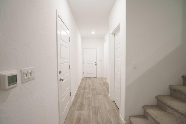 5769 W Austin Way, Fresno, CA 93722 - corridor with light wood-type flooring and stairway